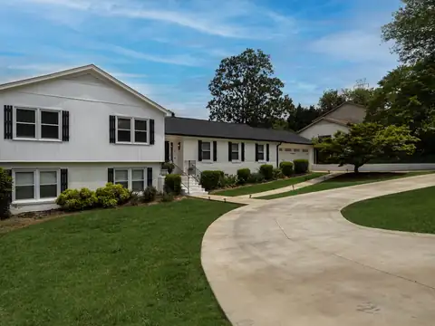 Curving front walkway leading to a white two-story house