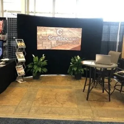 Concrafters home show booth with a patio table on a stamped floor