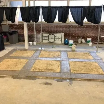 Colored concrete panels with gray borders on an exhibit floor