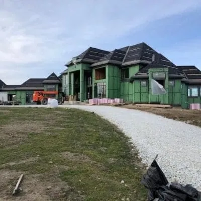 Stone base spread for a new driveway at a house under construction