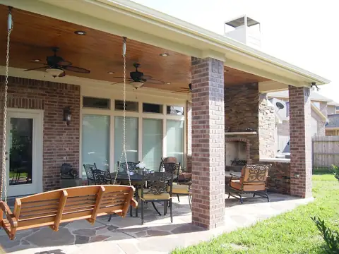 Covered patio with brick columns and a stamped stone-pattern floor